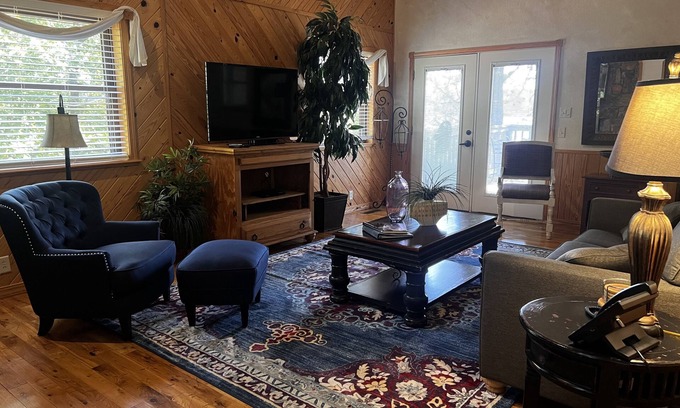 Mount Ida Cottage | Lake view two bedroom, two bath loft, log-sided cottage with private hot tub overlooking Lake Ouachita. by RedAwning