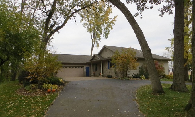 Pickett House | One bedroom and full bath in home 2 miles from EAA. Area with TV & refrigerator.