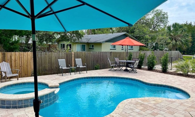 Butler Beach House | Paradise by the River - Relax in Style! New Pool and Heated Spa!