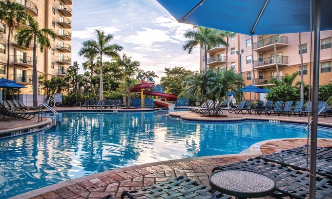 Survey Creek Resort | Relax at our Palm Tree secluded Resort with a poolside bar and waterslide