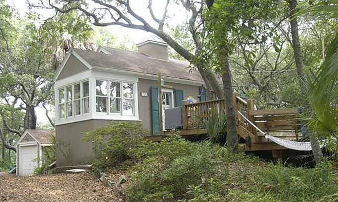 Folly Beach Cottage | Romantic, cozy cottage nestled amongst live oaks & palms, a block from beach.