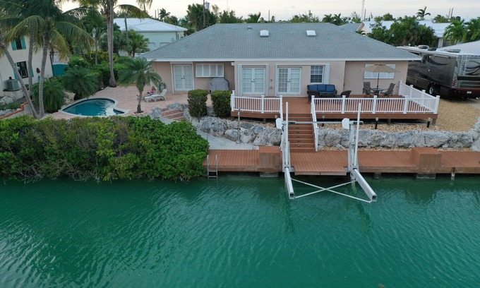 Cudjoe Gardens House | Sunset view from pool and deck area. Dock includes lift. Can accommodate pets.