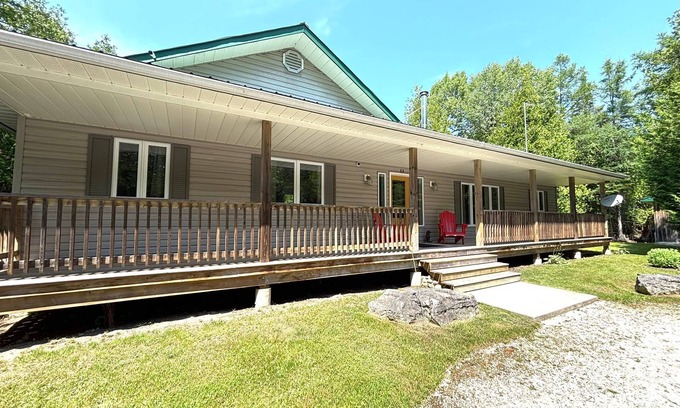 Lion's Head Cabin | This bright and spacious retreat blends modern comfort with cozy cottage charm. Featuring a fully equipped kitchen, multiple cozy bedrooms, stylish bathrooms, and inviting living spaces with a wood-burning fireplace.