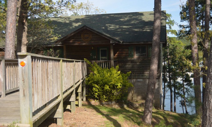 Mount Ida Cottage | Two bedroom, two bath, log-sided, luxury Harbor North cottage overlooking Lake Ouachita. by RedAwning