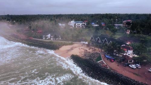 Varkala Hotel | West Bay Palm TreeHeritage Beach Resort