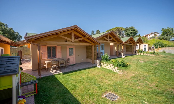 San Brizio Apartment | Wooden house with porch and garden