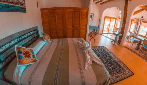 Master Suite King Bed with Partial Ocean View and Balcony
