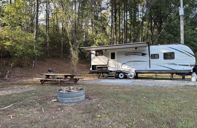 Camper in country setting beside water, near Burning Star Wildlife area
