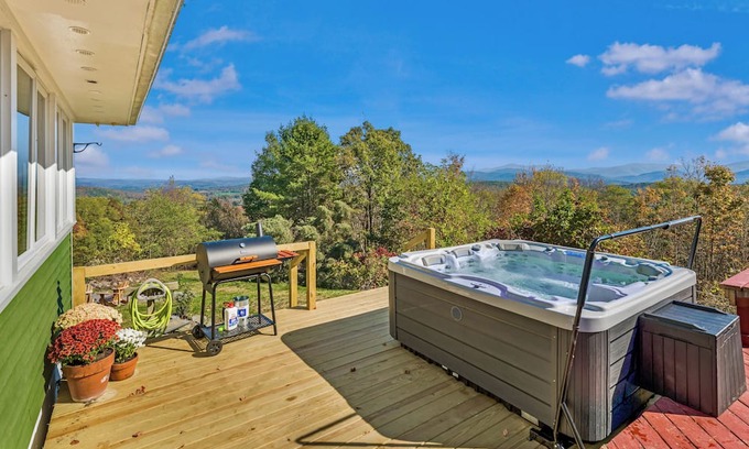 Cambridge House | Bright hilltop retreat with stunning mountain views, wrap-around windows, and cozy seating to take it all in. Nestled on a private, scenic property minutes from charming Cambridge village—perfect for a peaceful getaway year-round.
